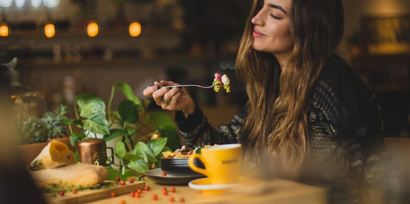 woman holding fork in front table