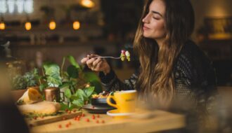 woman holding fork in front table