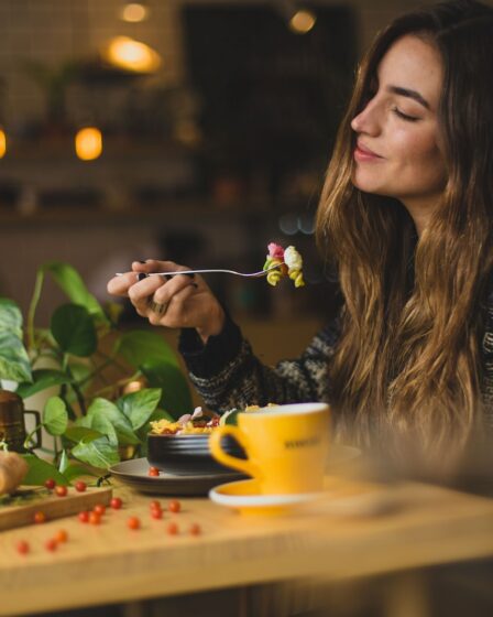 woman holding fork in front table